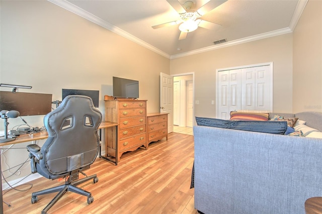 home office featuring ceiling fan, light wood-type flooring, visible vents, and crown molding