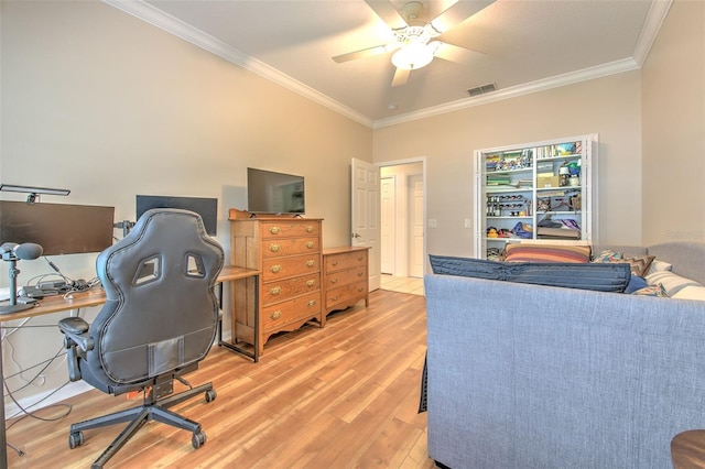 office area featuring ornamental molding, visible vents, light wood-style flooring, and a ceiling fan