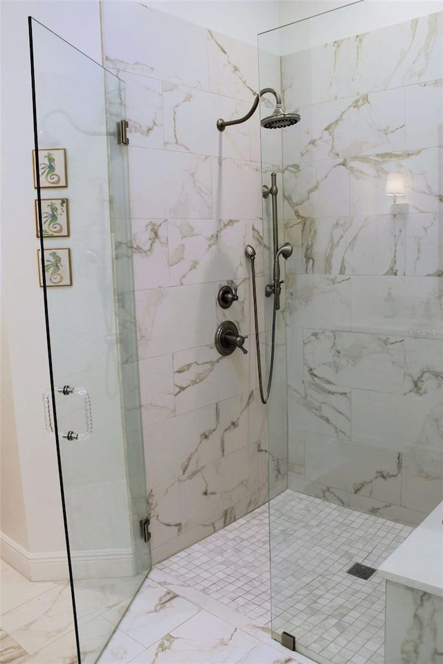 bathroom with marble finish floor and a marble finish shower