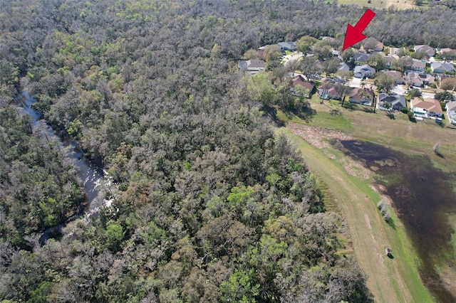 drone / aerial view with a residential view and a wooded view