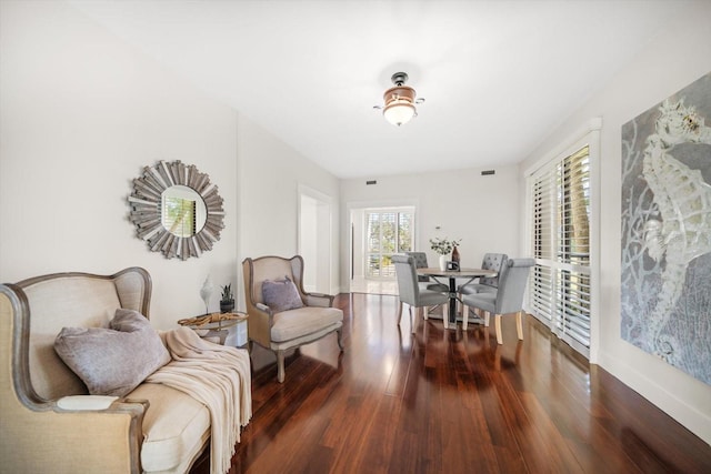 sitting room featuring dark wood-type flooring