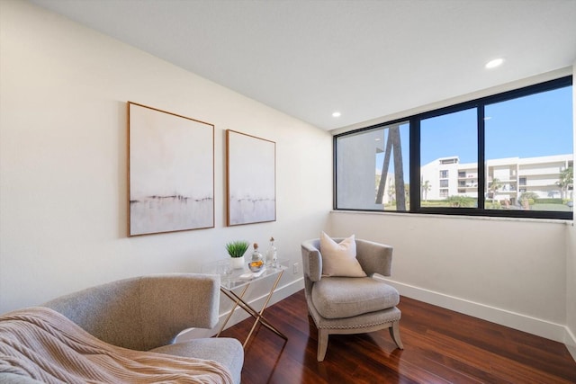 sitting room featuring dark wood-style flooring, recessed lighting, and baseboards