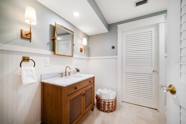 bathroom with wainscoting, visible vents, and vanity