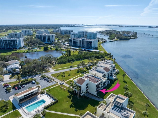 birds eye view of property with a water view and a city view