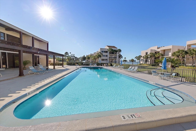 pool with fence and a patio