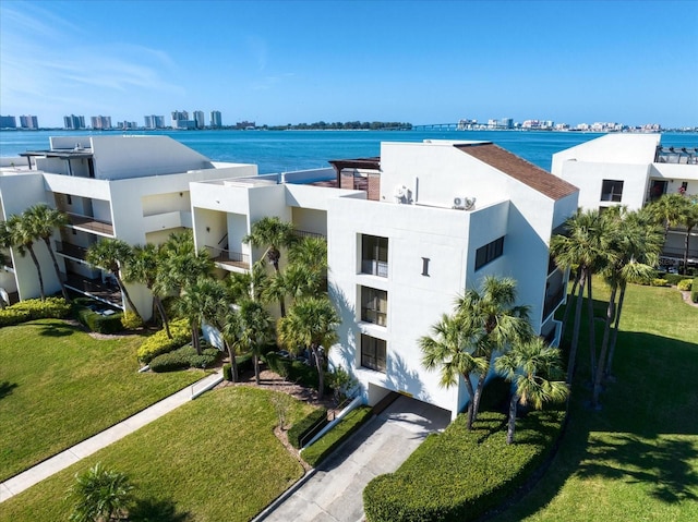 birds eye view of property featuring a view of city and a water view