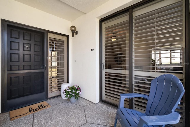 property entrance with stucco siding