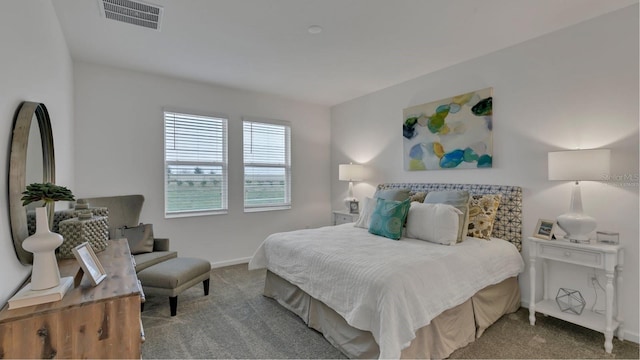 bedroom with carpet, visible vents, and baseboards