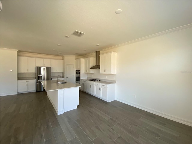 kitchen featuring dark wood finished floors, visible vents, stainless steel appliances, and wall chimney range hood