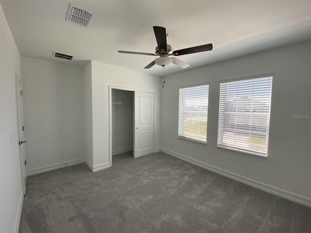 unfurnished bedroom featuring visible vents, baseboards, carpet, and a closet