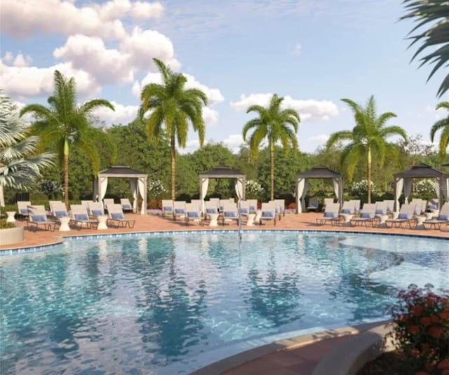 community pool with a gazebo and a patio area