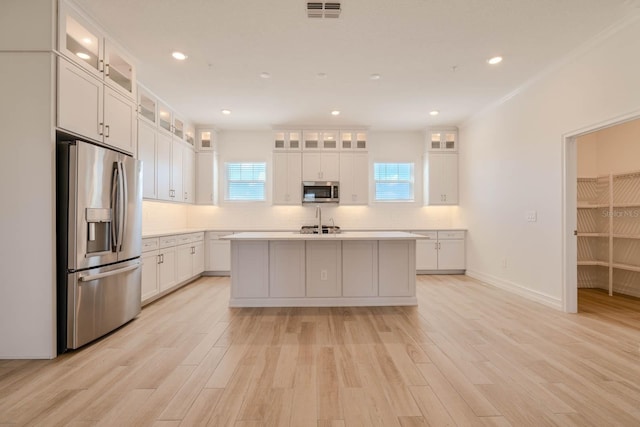 kitchen with visible vents, appliances with stainless steel finishes, light countertops, and light wood-style flooring