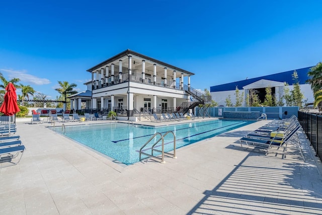 pool featuring a patio and fence