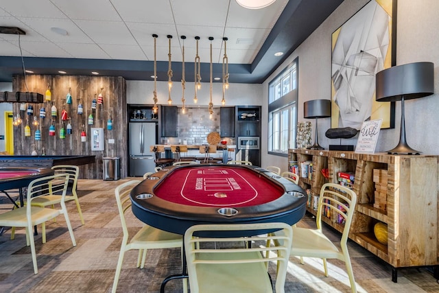 game room featuring a tray ceiling