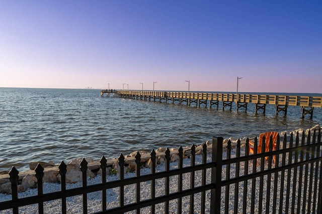 view of dock with a pier and a water view