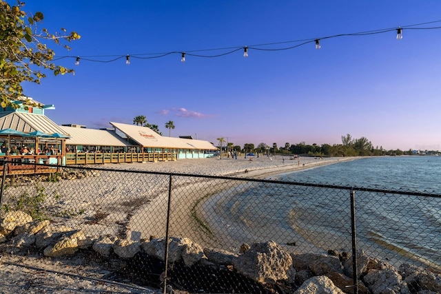 view of yard featuring a water view and fence