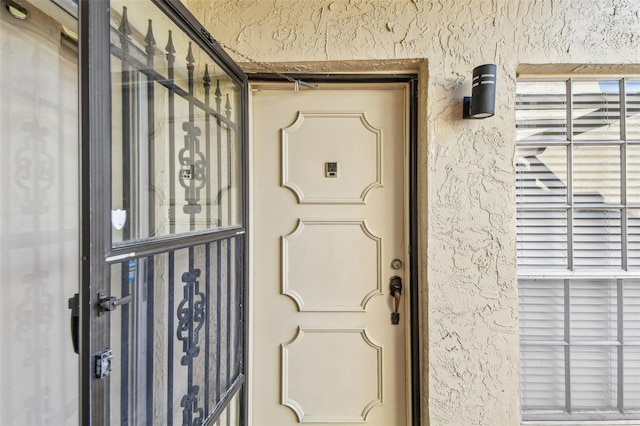 doorway to property with stucco siding