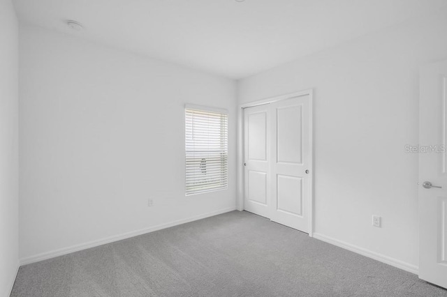 1931 Rosewood Cir, Lakeland, FL 33810 - unfurnished bedroom featuring carpet and a closet
