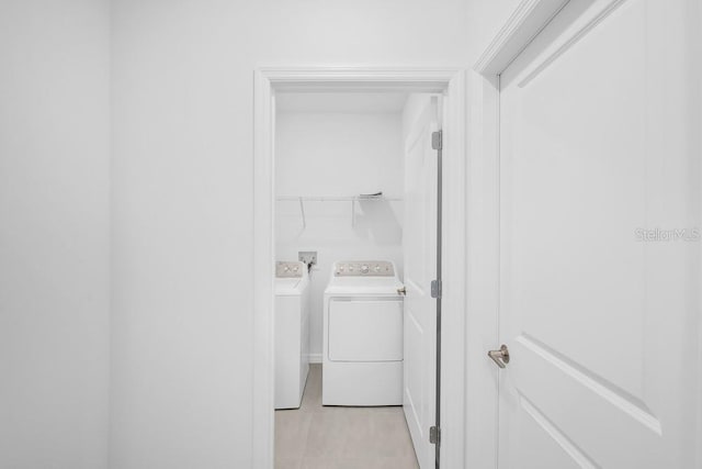 1931 Rosewood Cir, Lakeland, FL 33810 - washroom with washing machine and clothes dryer and light tile patterned floors