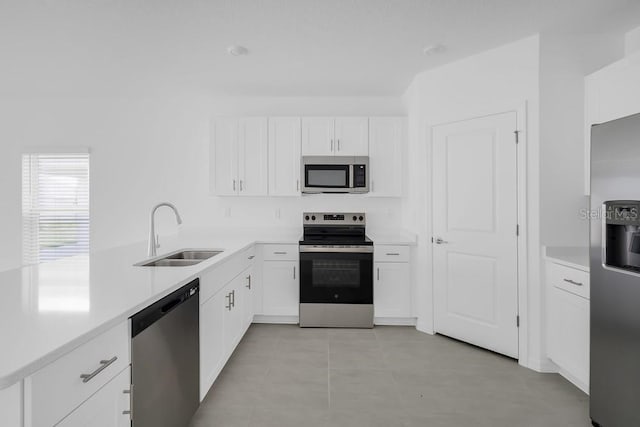 1931 Rosewood Cir, Lakeland, FL 33810 - kitchen with appliances with stainless steel finishes, white cabinetry, light countertops, and light tile patterned flooring