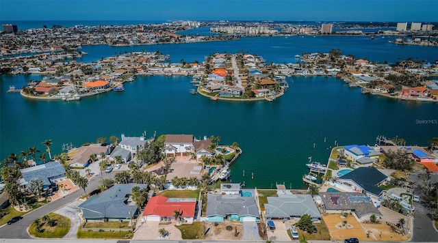 drone / aerial view with a water view and a residential view