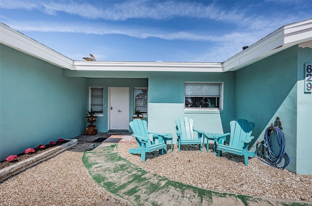 doorway to property with stucco siding