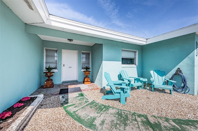 entrance to property with stucco siding