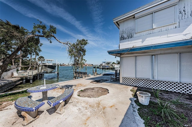 exterior space featuring a water view, boat lift, and a dock