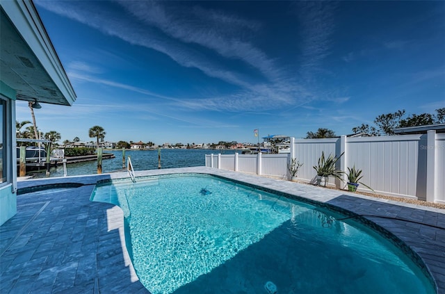 pool featuring a water view and a fenced backyard