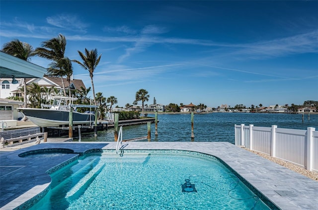 outdoor pool featuring boat lift, a dock, a water view, and fence