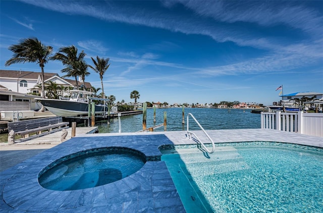 pool with an in ground hot tub, a boat dock, a water view, and boat lift