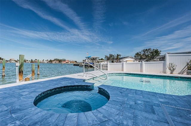 629 59th Ave, St Pete Beach, FL 33706 - outdoor pool with fence, a patio, a boat dock, a water view, and an in ground hot tub