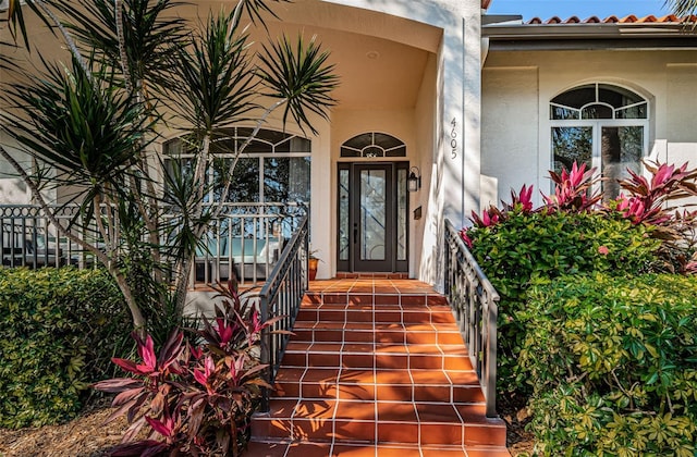 property entrance with stucco siding