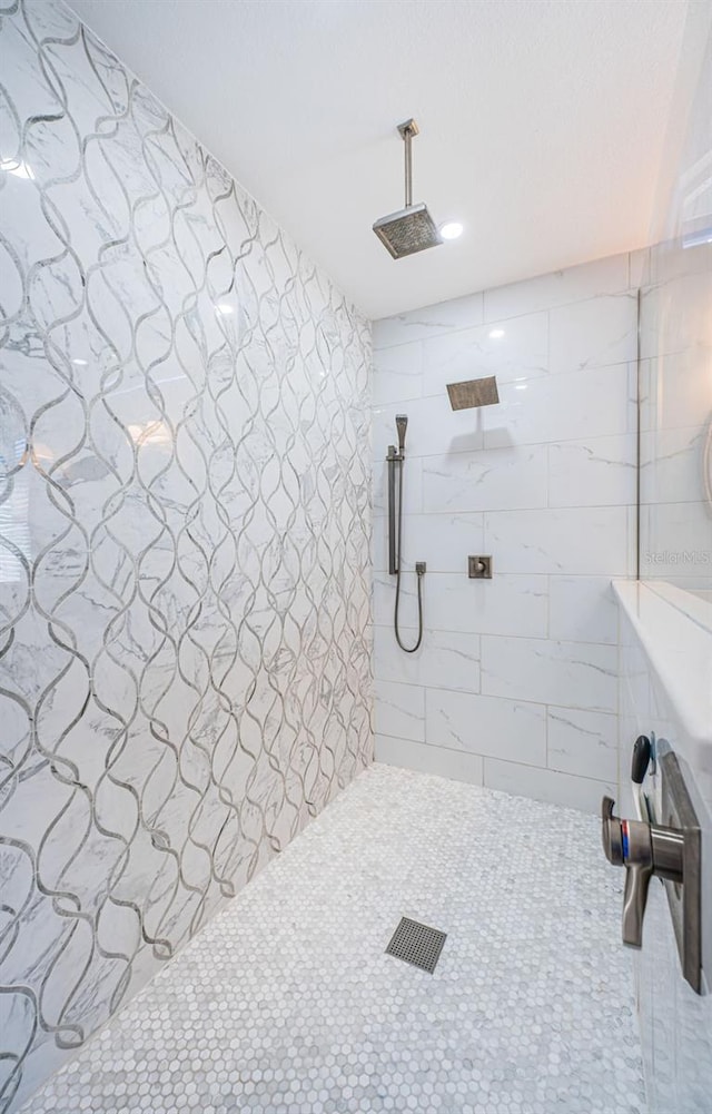 bathroom with tiled shower