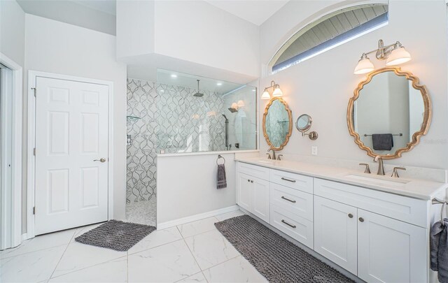 bathroom featuring a walk in shower, marble finish floor, double vanity, and a sink