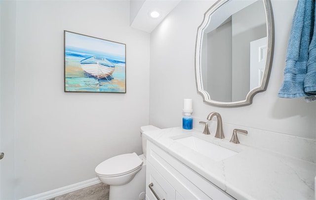 half bath with recessed lighting, toilet, vanity, and baseboards