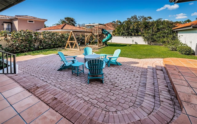 view of patio / terrace with a fenced backyard and a playground