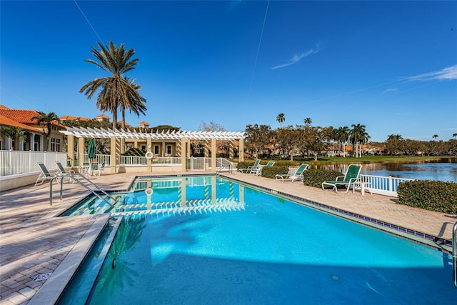 pool with a patio area, fence, and a pergola