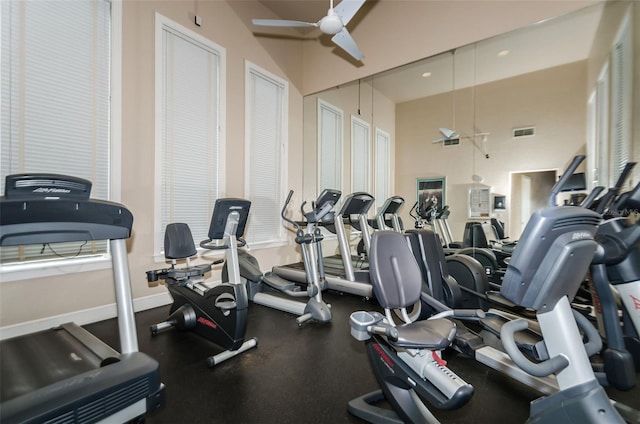 workout area featuring visible vents, a ceiling fan, and baseboards