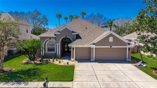 view of front of house featuring a shingled roof, a front lawn, stucco siding, a garage, and driveway