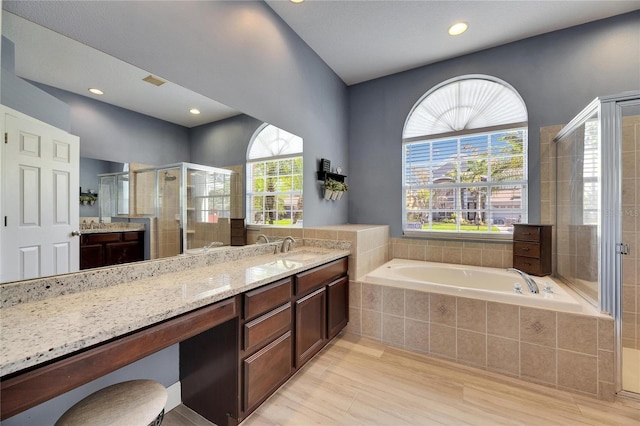 full bath with visible vents, vanity, a bath, and a shower stall