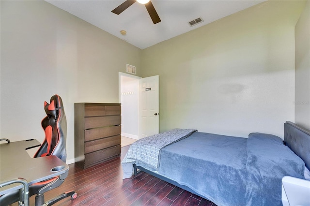 bedroom featuring baseboards, wood finished floors, visible vents, and ceiling fan