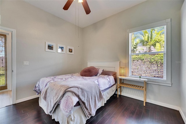 bedroom with a ceiling fan, baseboards, and dark wood-style flooring