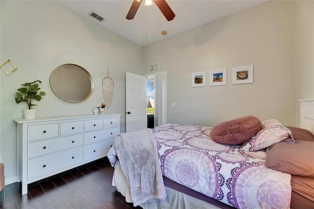 bedroom with visible vents, dark wood-type flooring, ceiling fan, and vaulted ceiling