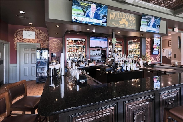 bar featuring tile patterned flooring, visible vents, and a dry bar