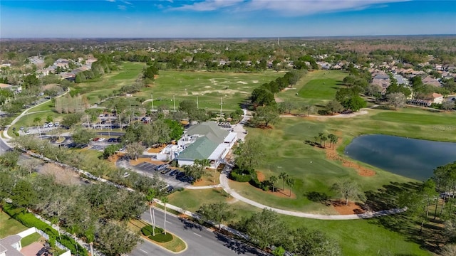 drone / aerial view with golf course view and a water view