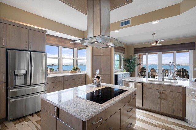 4951 Bacopa Ln S Unit 801, Saint Petersburg, FL 33715 - kitchen featuring visible vents, island exhaust hood, a sink, a kitchen island, and stainless steel appliances