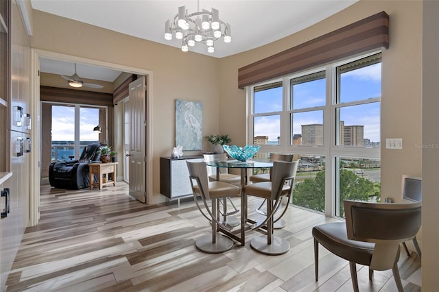 4951 Bacopa Ln S Unit 801, Saint Petersburg, FL 33715 - dining area with a chandelier, plenty of natural light, light wood-style floors, and a view of city