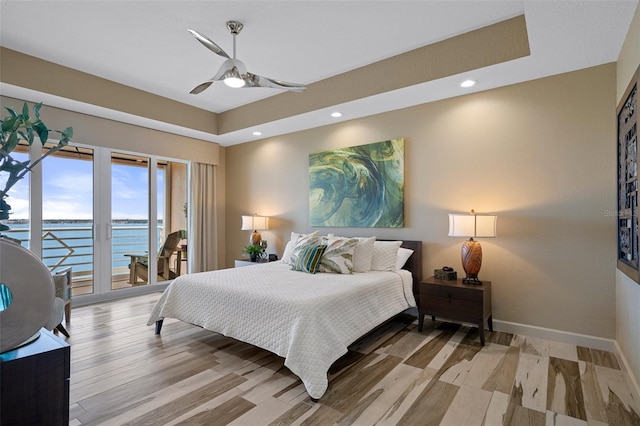 4951 Bacopa Ln S Unit 801, Saint Petersburg, FL 33715 - bedroom featuring light wood finished floors, baseboards, a water view, recessed lighting, and access to outside