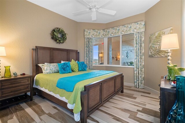 4951 Bacopa Ln S Unit 801, Saint Petersburg, FL 33715 - bedroom featuring baseboards, a ceiling fan, and light wood finished floors